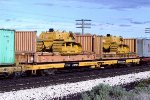 Trailer Train flat TTWX #978702 loaded with bulkhaed containers carrying Komatsu 65P bulldozers.